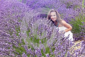 Beautiful girl smiling in a field of lavender