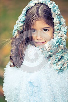 Beautiful girl smiling with winter hoodie and fluffy scarf