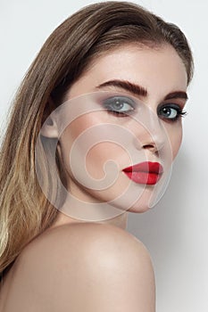 Beautiful girl with smoky eye makeup and red lips