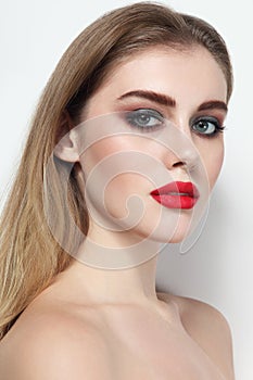 Beautiful girl with smoky eye makeup and red lips