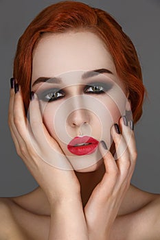 Beautiful girl with smoky eyes and red lips