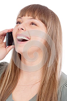 Beautiful girl speaks by phone and laughs photo