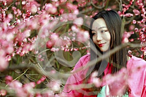 Beautiful girl in a spring blooming garden