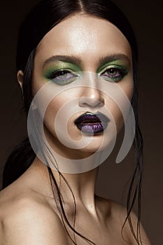 Beautiful girl with spring green makeup and vampire lips. beauty face.