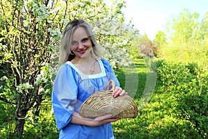 Beautiful girl standing in the apple orchard