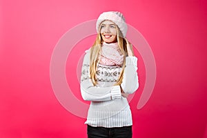 Beautiful girl standing isolated on red background, in warm pink