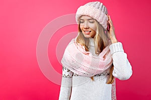 Beautiful girl standing isolated on red background, in warm pink