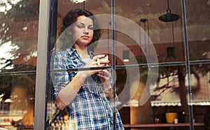 Beautiful girl standing near window