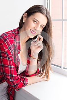 Young girl talking on phone.