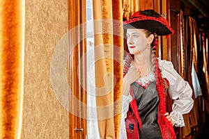 Beautiful girl in steampunk costume in an old train carriage