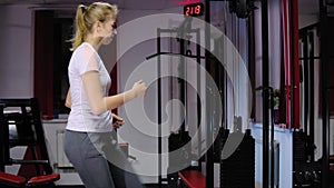 Beautiful girl on the step board during exercise in the gym.