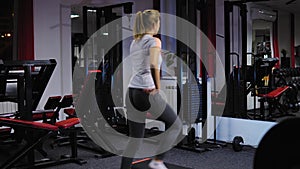 Beautiful girl on the step board during exercise in the gym.