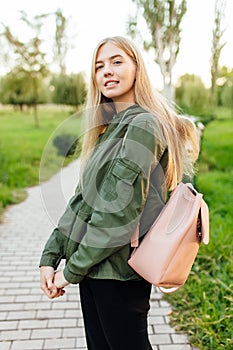 Beautiful girl student, dressed in a jacket with a briefcase, wa