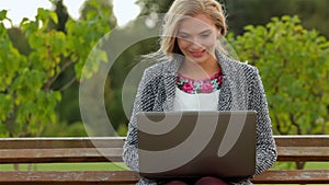 Beautiful girl student uses a laptop