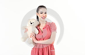 Beautiful girl in studio is holding a teddy bear