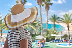 Beautiful girl in sun hat enjoying amazing sea view photo