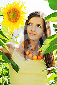 Beautiful girl among the sunflowers