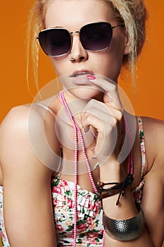 Beautiful girl in sunglasses.beauty woman.orange background