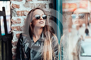 Beautiful girl in sunglasses posing on camera