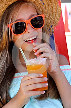 Beautiful girl in sunglasses and slush on beach
