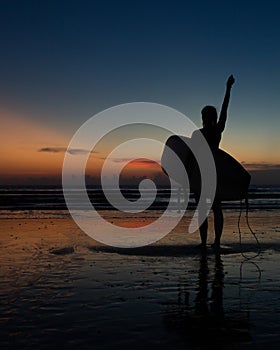 beautiful girl with a surfboard at sunset.