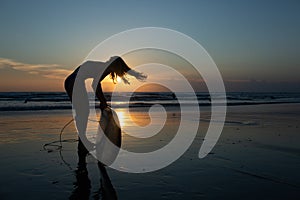 beautiful girl with a surfboard at sunset.