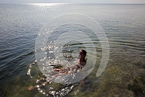 Beautiful girl swimming in the sea