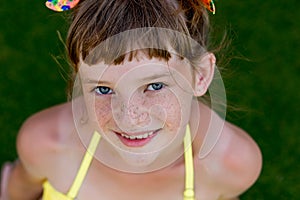 Young girl in a swimsuit on a shelf by the pool photo