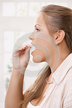 Beautiful girl taking pink chewing gum