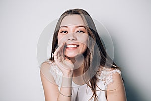 Beautiful girl telling a secret .Portrait young happy woman.