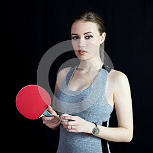 Beautiful girl with a tennis racket and a ball.