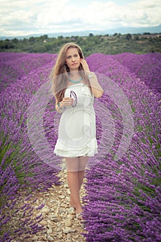 Beautiful girl with a thoughtful look on a lavender field