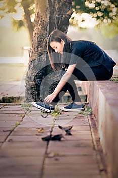 Beautiful girl ties shoelaces