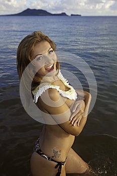 Beautiful girl topless in the ocean