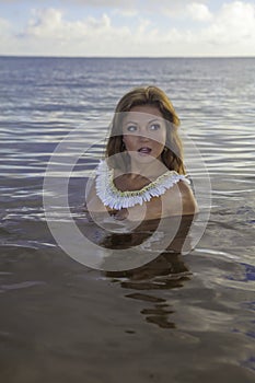 Beautiful girl topless in the ocean