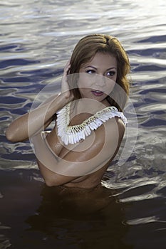 Beautiful girl topless in the ocean