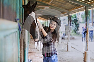 Beautiful girl touching horse