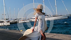 Beautiful girl tourist walking on Spetses embankment, Greece