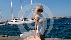 Beautiful girl tourist walking on Spetses embankment, Greece