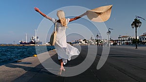 Beautiful girl tourist walking on Spetses embankment, Greece