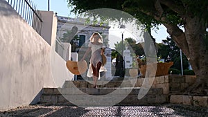 Beautiful girl tourist walking in the streets of Spetses, Greece