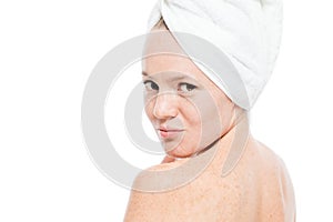 Beautiful girl in a towel looked back at the camera