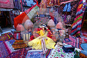 Beautiful girl at traditional carpet shop in Goreme city, Cappadocia in Turkey