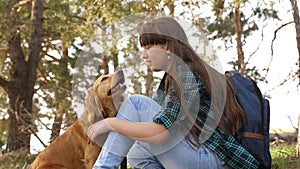 Beautiful girl travels with pet. tourist girl in forest on halt with a dog. mistress plays with hunting hound. mistress