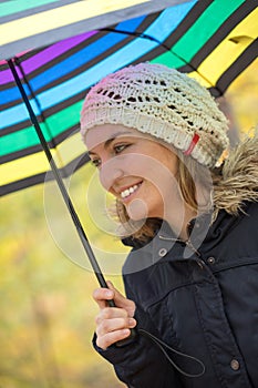 Beautiful girl with umbrella in the forest, autumn time