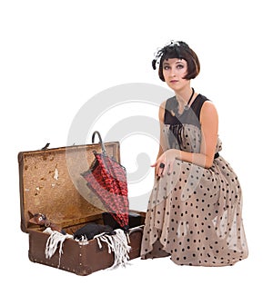 Beautiful girl with umbrella and old suitcase