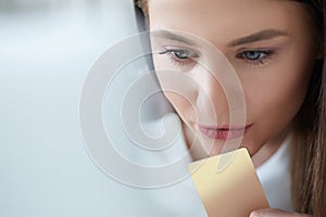 Beautiful girl using laptop to shop online with credit card. Smiling woman using laptop and credit card for online