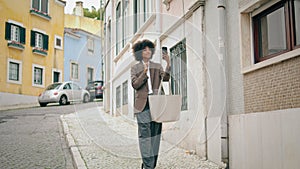 Girl using smartphone selfie standing on street. Young woman taking photo.