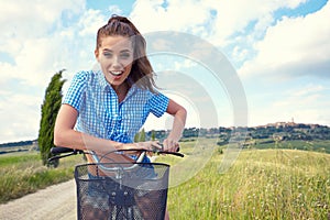 Beautiful girl with vintage bike outdoor, Tuscany summer time