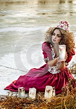 Beautiful girl in vintage red dress with a rose